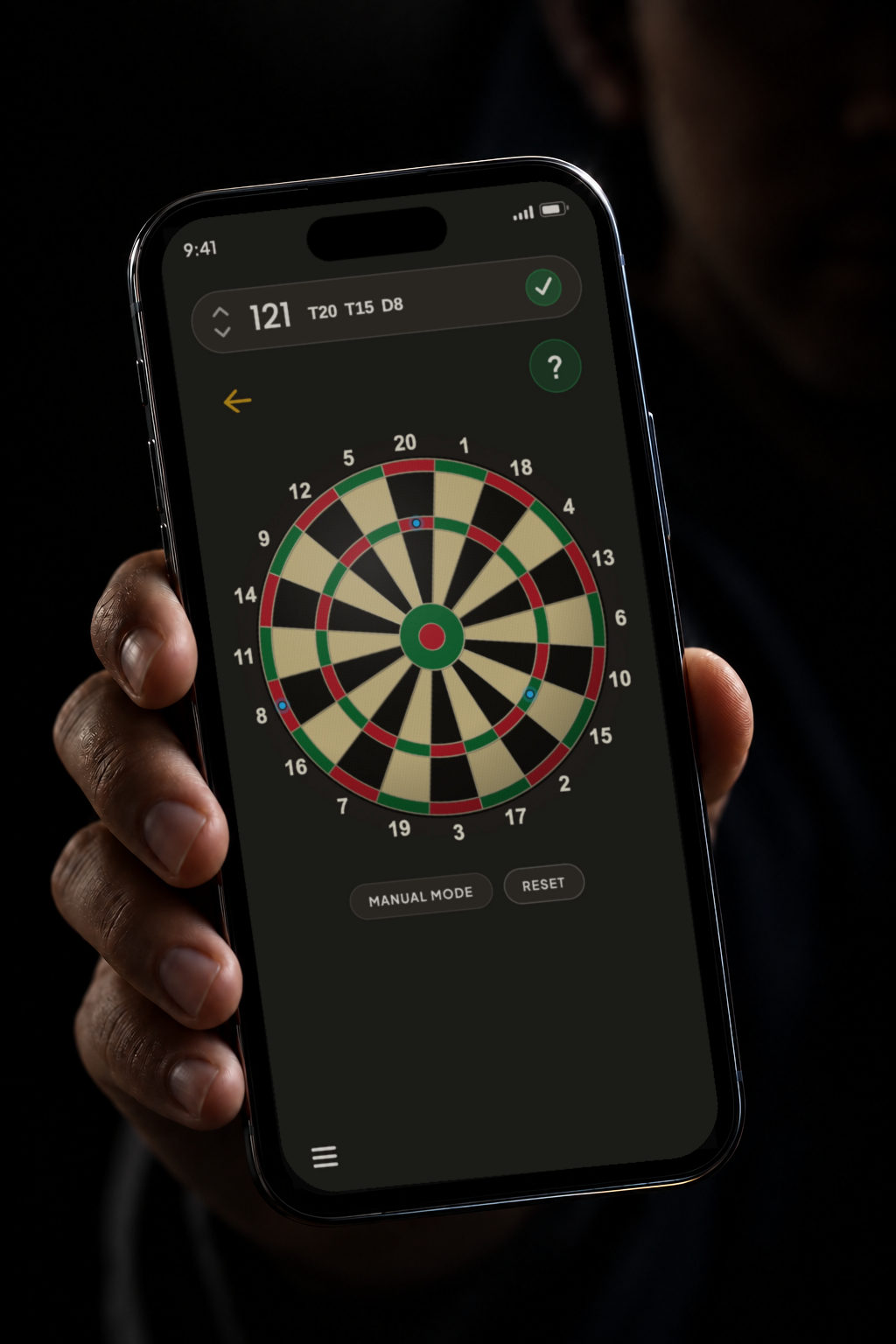 A hand holding a phone running Darts Tapout: 121 checked out with a green tick